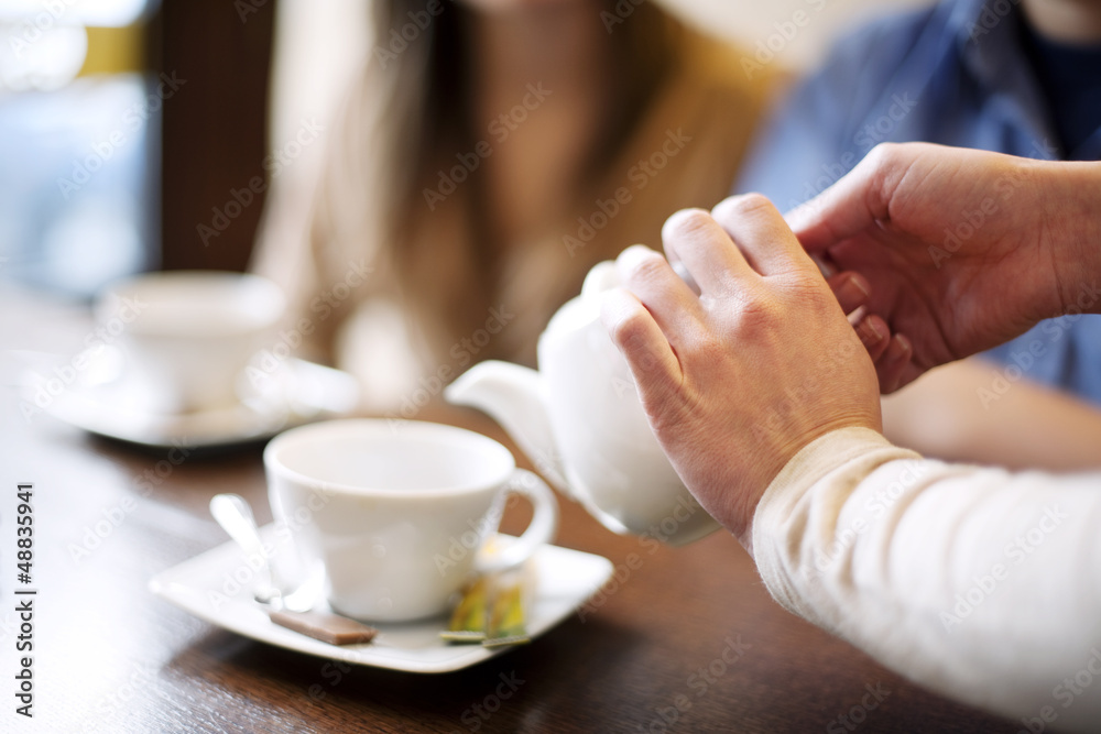 Waitress pouring cup of coffee/tea Waitress pouring cup of coffee/tea