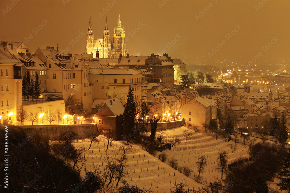 Night snowy winter Prague with gothic Castle, Czech Republic
