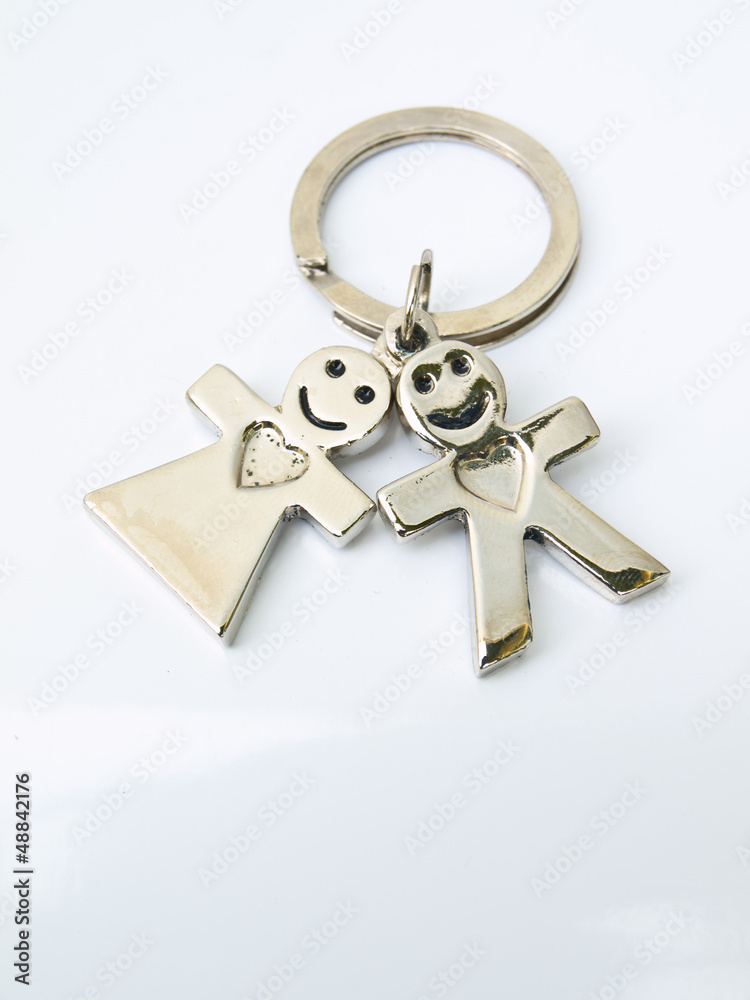 A  miniature groom and bride keychain isolated on white backgrou
