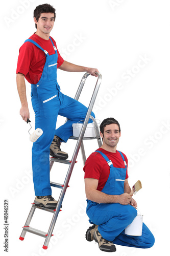 Two male decorators wearing the same outfit