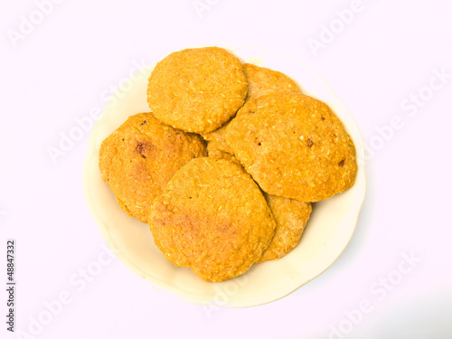 Pile of cookies on a Chiness porcelane plate isolated on white b