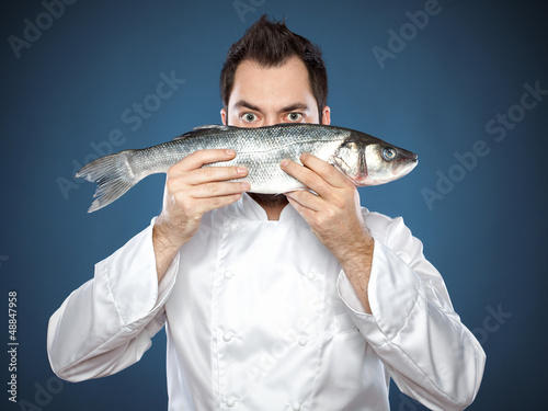 Photography Male chef with seabass fish