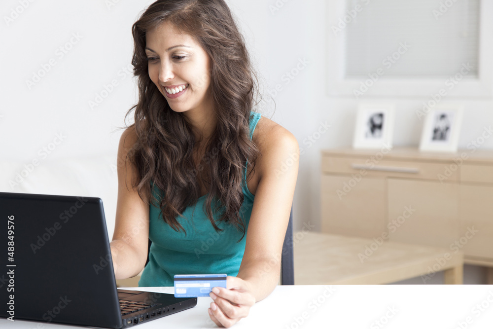 Mixed race woman shopping online with credit card Mixed race woman shopping online with credit card