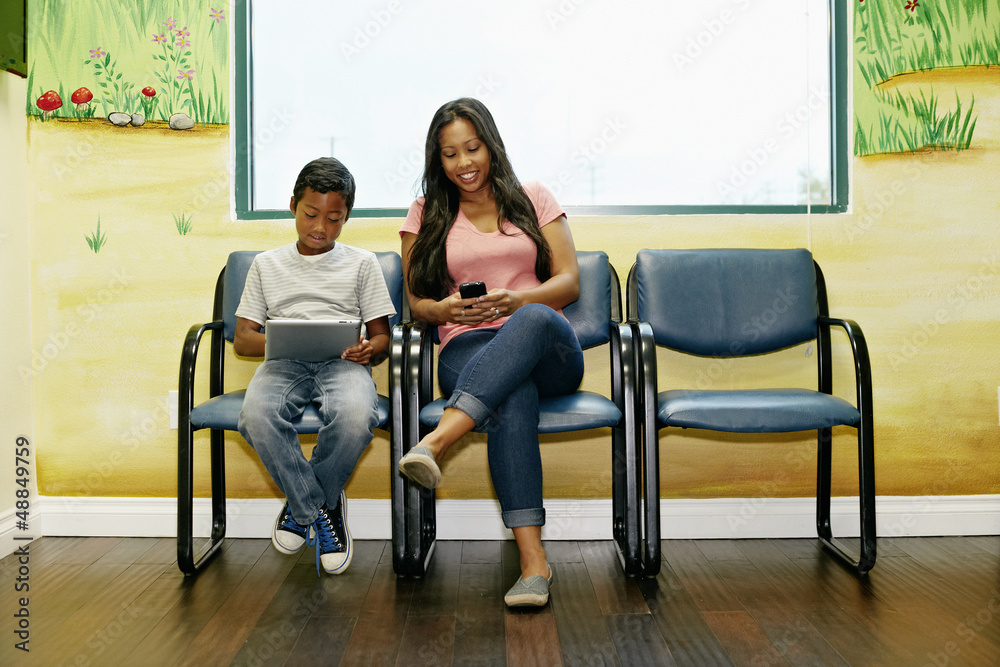 Mixed race boy and mother in waiting room Mixed race boy and mother in waiting room