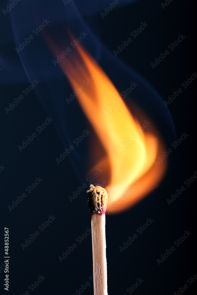 Ignition of a match, with smoke on dark background Ignition of a match, with smoke on dark background