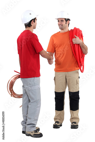 Plumbers shaking hands