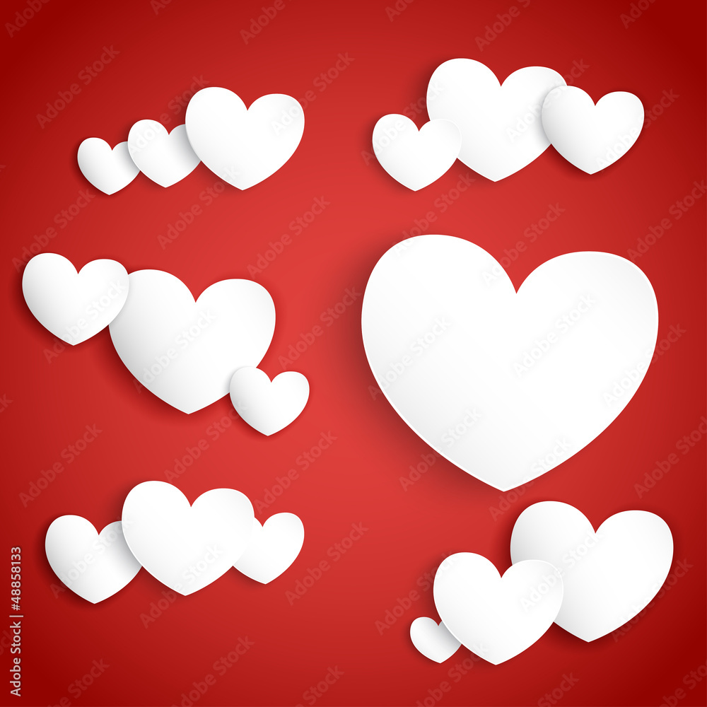 White paper hearts on red background