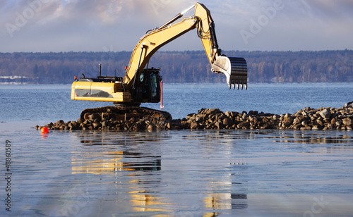 giant bulldozer at sunset, dredging works