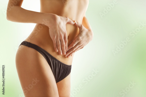 Tableau sur toile Young woman touching her stomach