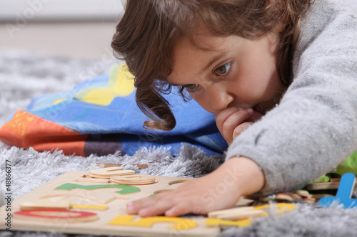 Photography Child playing with a puzzle