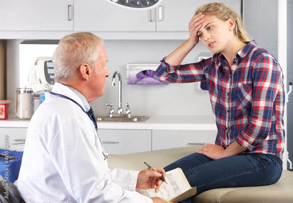 Obraz premium Teenage Girl Visits Doctor's Office With Headaches