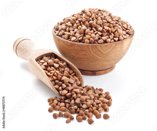 buckwheat in a wooden bowl isolated on white