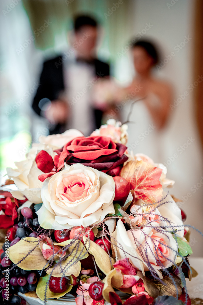 Beautiful bridal bouquet and bride and groom on background Beautiful bridal bouquet and bride and groom on background