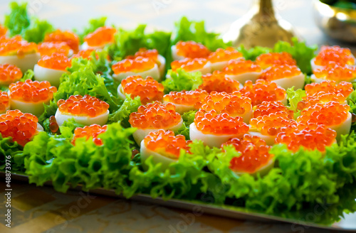 Stuffed eggs with red caviar