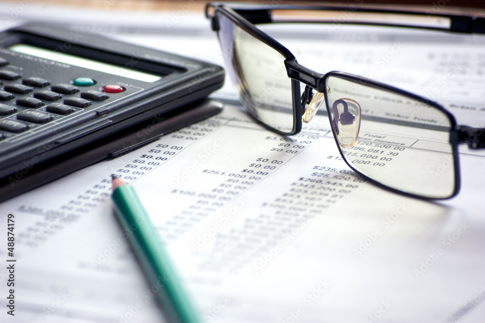 accounting files with glasses and mathematical computer accounting files with glasses and mathematical computer