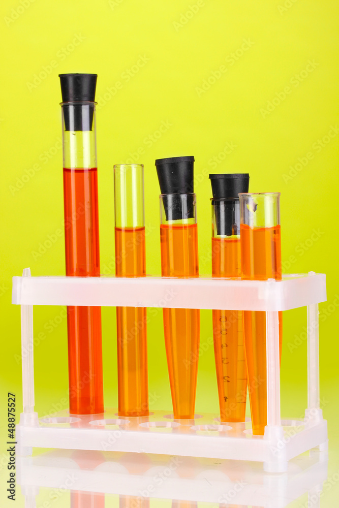 Test-tubes with a colorful solution on green background Test-tubes with a colorful solution on green background