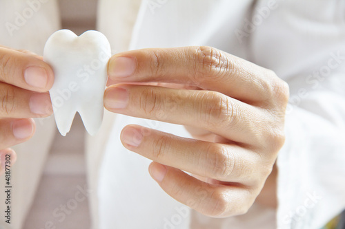 dentist holding molar ,dental concept