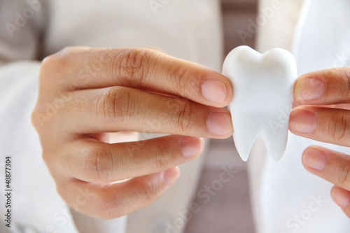 dentist holding molar