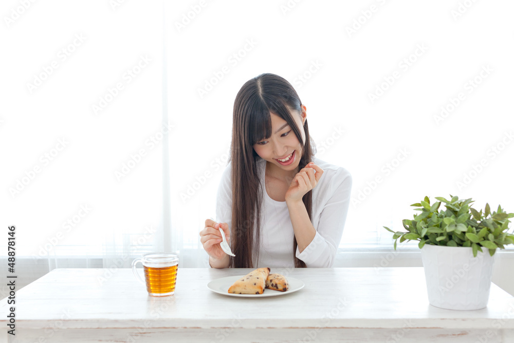 attractive asian woman eating sweets