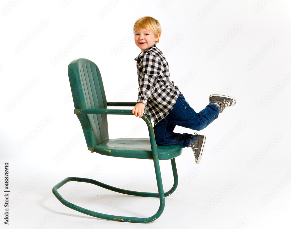 Boy Having Fun On Chair