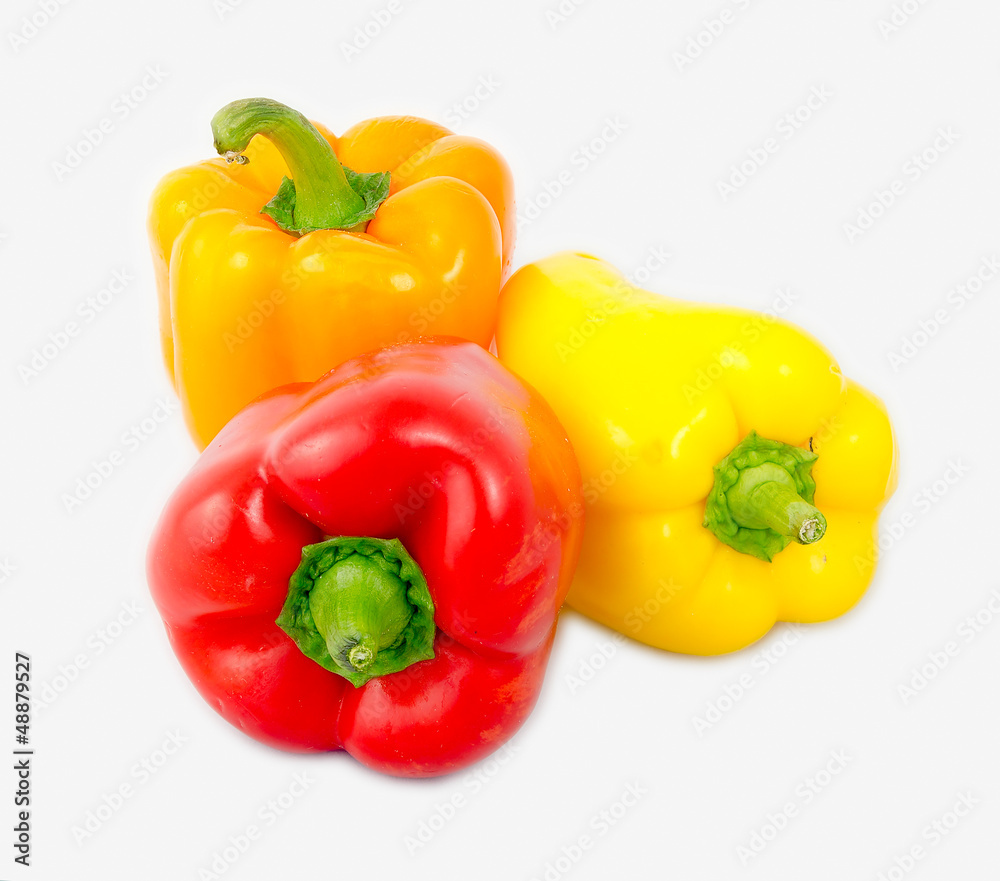 A mix of differently colored bell peppers isolated on white back A mix of differently colored bell peppers isolated on white back
