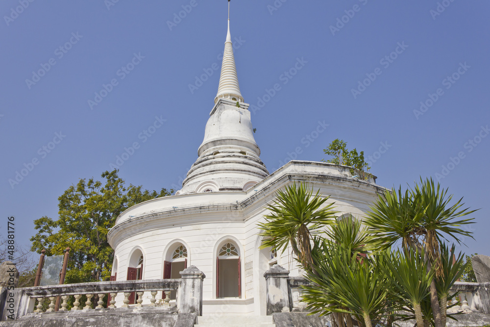 Historic white stupa in thailand, against blue sky