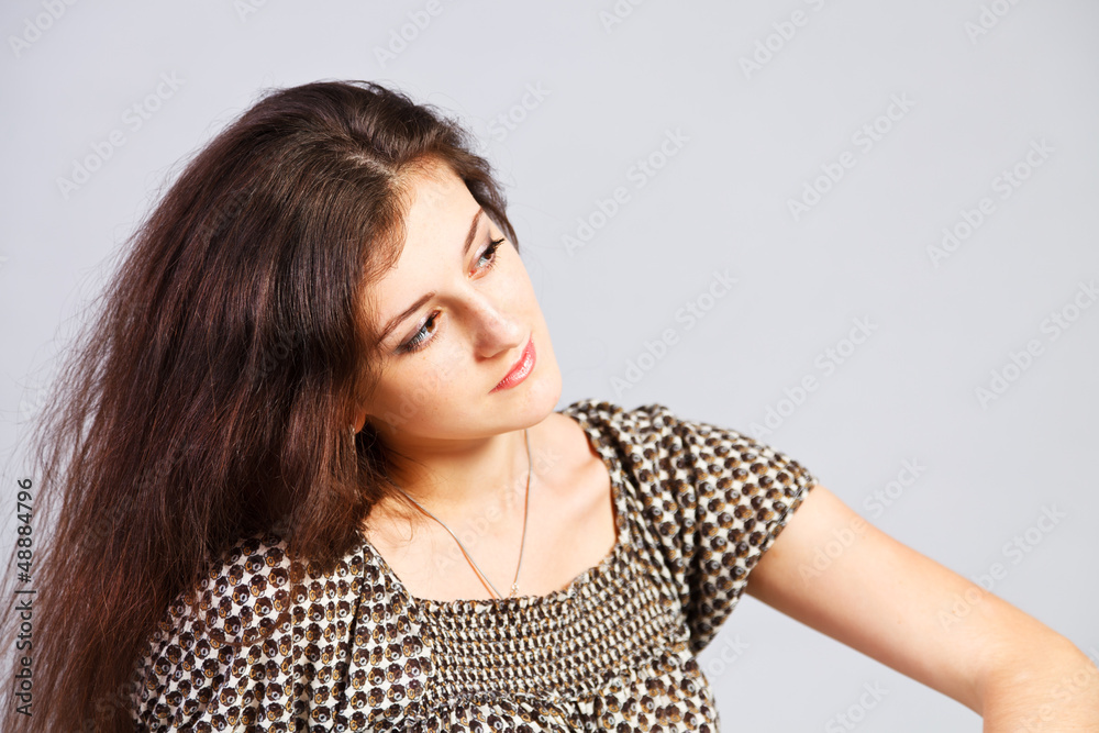 Brunette girl`s portret isolated on gray background. Brunette girl`s portret isolated on gray background.
