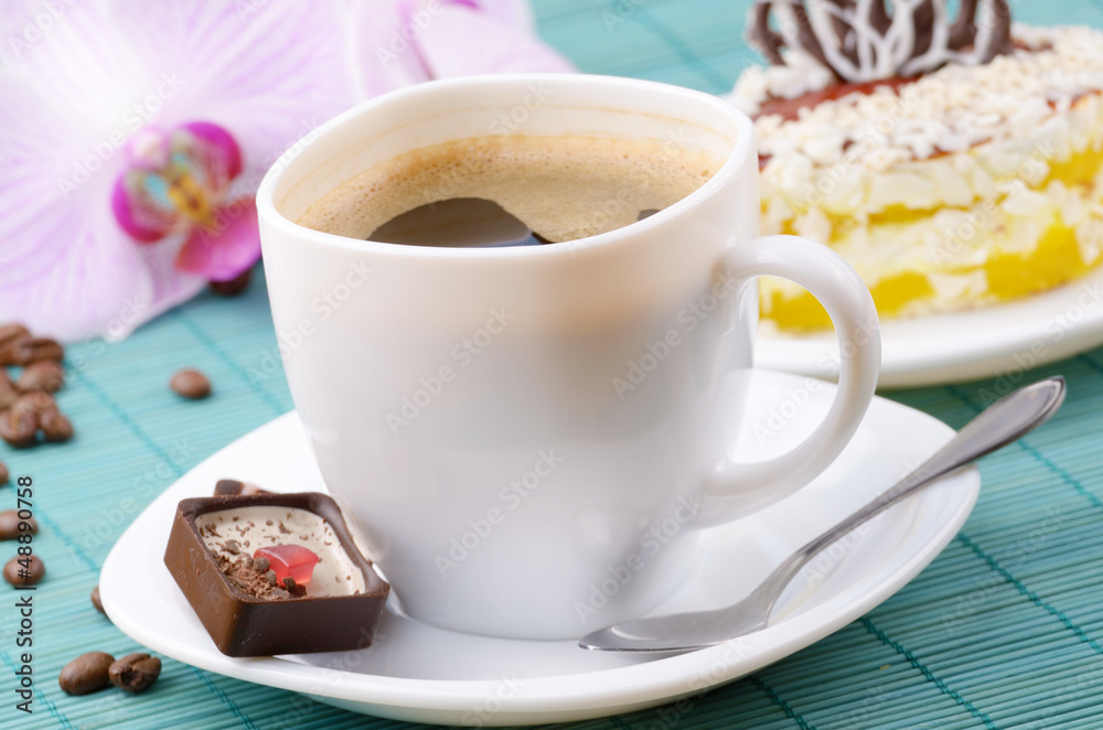 Coffee cup and milk chocolate candy closeup Coffee cup and milk chocolate candy closeup