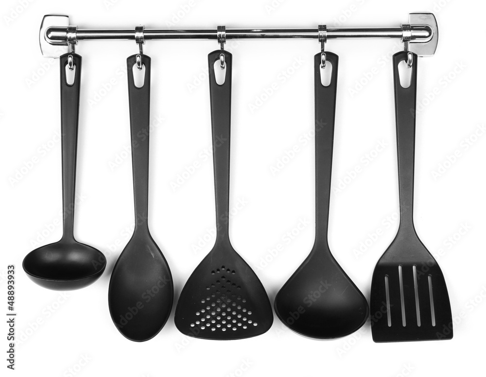 Black kitchen utensils on silver hooks, isolated on white Black kitchen utensils on silver hooks, isolated on white