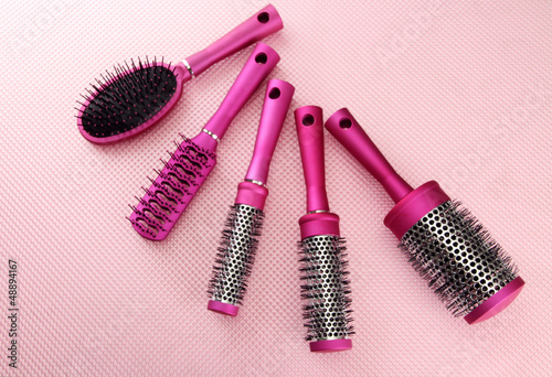 Fototapeta Naklejka Na Ścianę i Meble -  Comb brushes on pink background