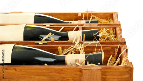 Bottles of old red wine in gift wooden box, isolated on white