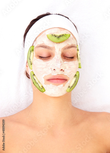 Young woman with clay facial mask
