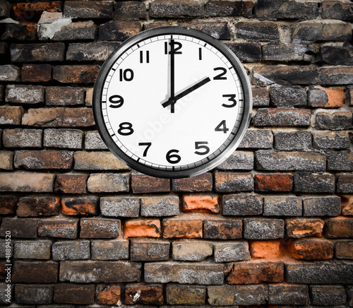 Retro clock on brick wall