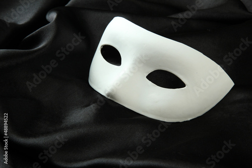 White mask, on black silk fabric