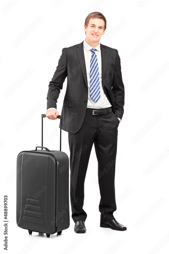 Full length portrait of a young businessman with a suitcase