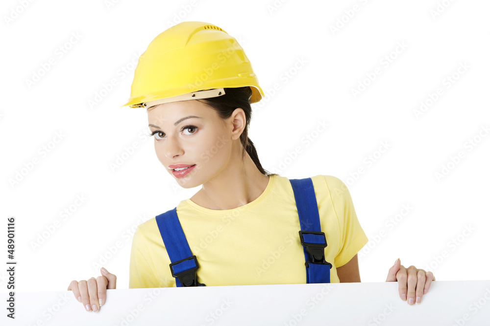 Female construction worker with blank board Female construction worker with blank board