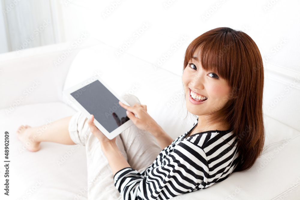 attractive asian woman using tablet computer attractive asian woman using tablet computer