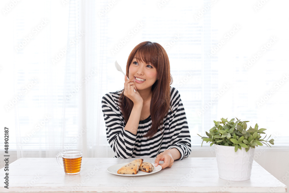 attractive asian woman eating sweets