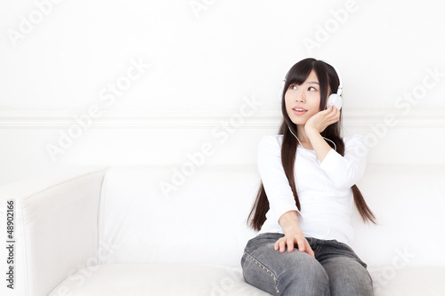 attractive asian woman listening to music