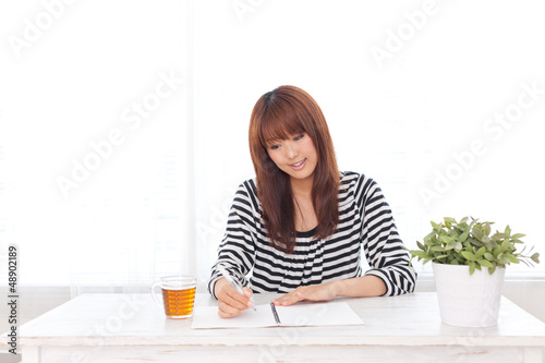 attractive asian woman writing