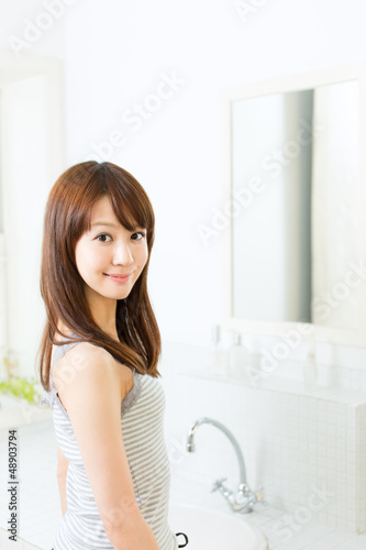 Beautiful asian woman relaxing in the bathroom