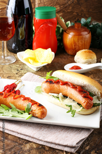 Hot Dog with sausage, ketchup and lettuce