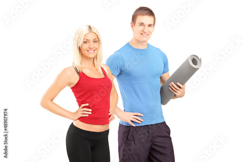 Young female and male athletes posing