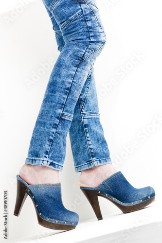 detail of woman wearing denim clogs