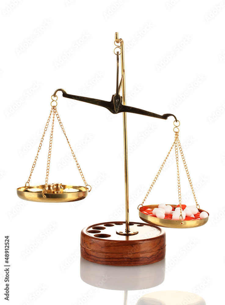 Classic scales with color pills isolated on white Classic scales with color pills isolated on white