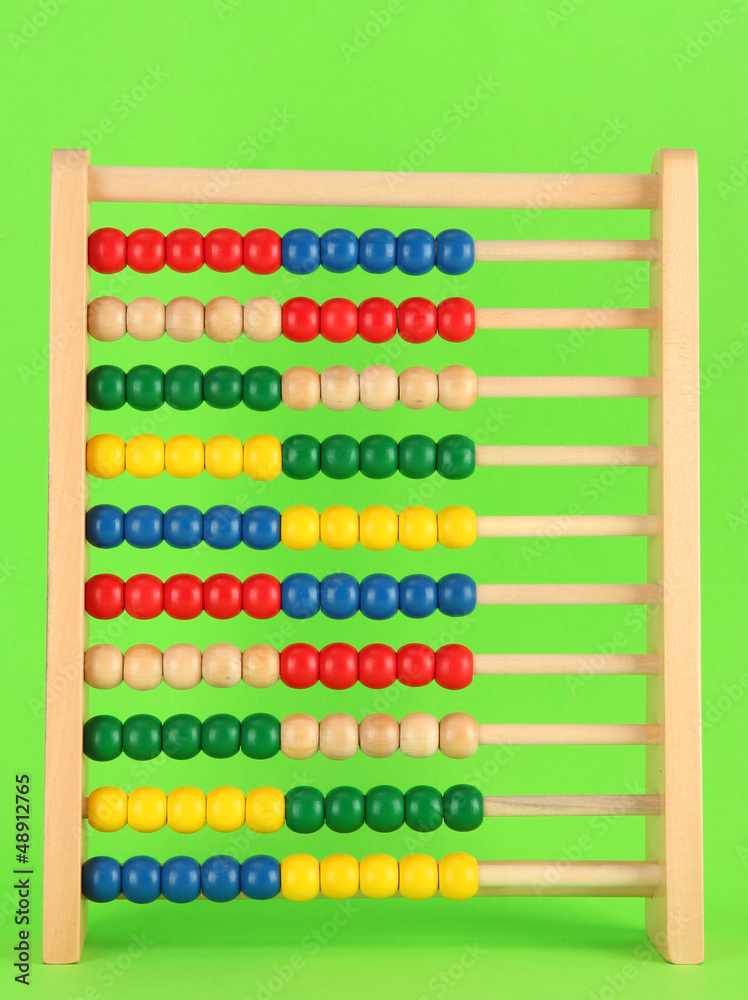 Bright wooden toy abacus, on green background Bright wooden toy abacus, on green background