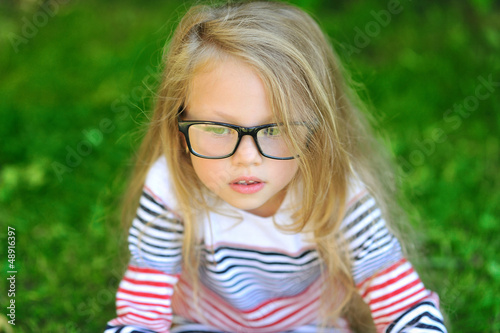 Closeup of a beautiful girl wearing glasses in a park