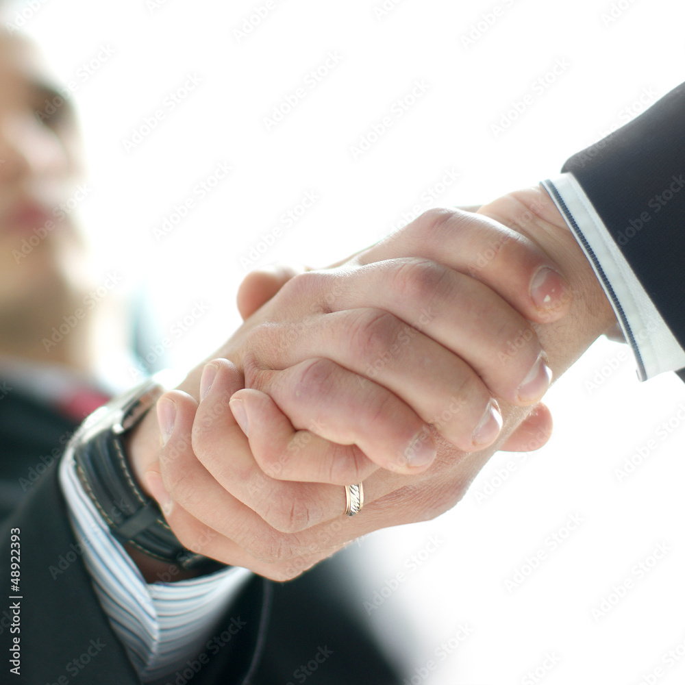 Close-up image of a handshake between two persons