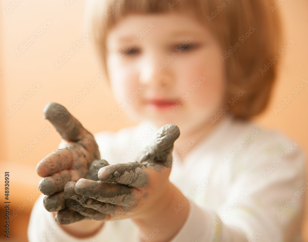 Little girl modelling clay toy