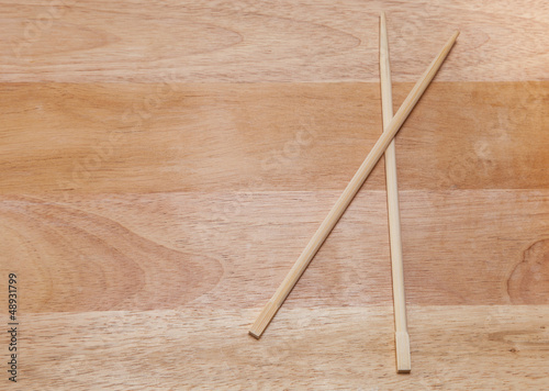 Chopsticks on a wooden background